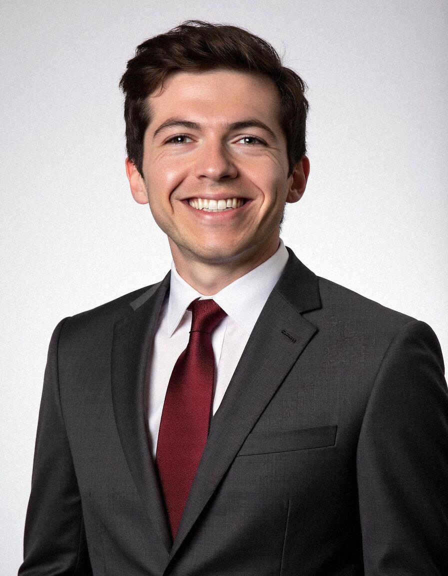 AI headshot of Ben: studio, white backdrop, charcoal suit and burgundy tie