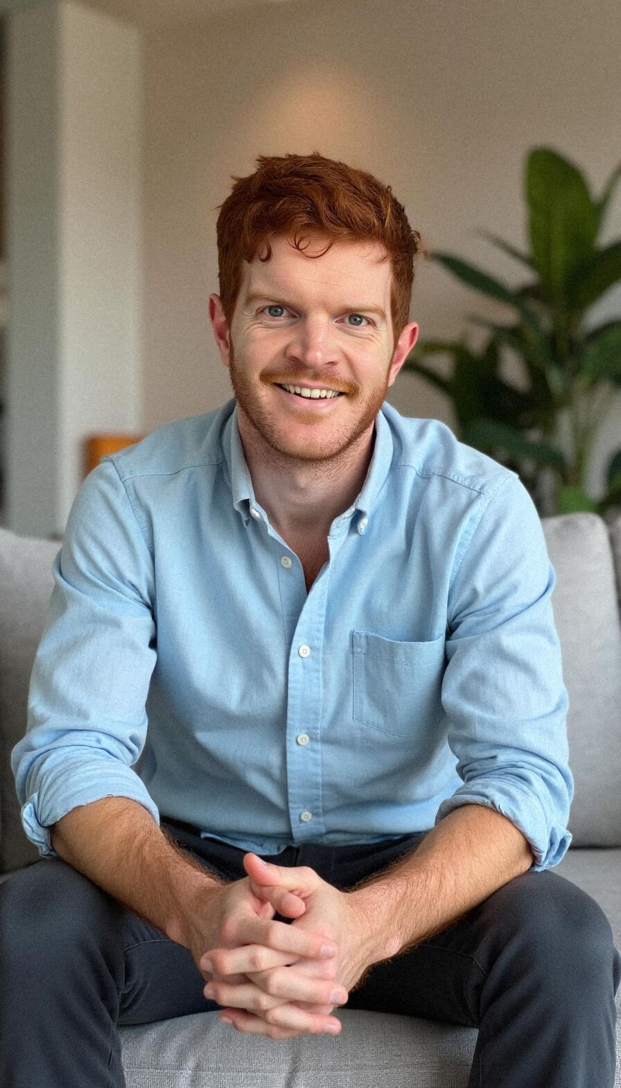 AI headshot of Cam: office sofa, light blue shirt (second run)