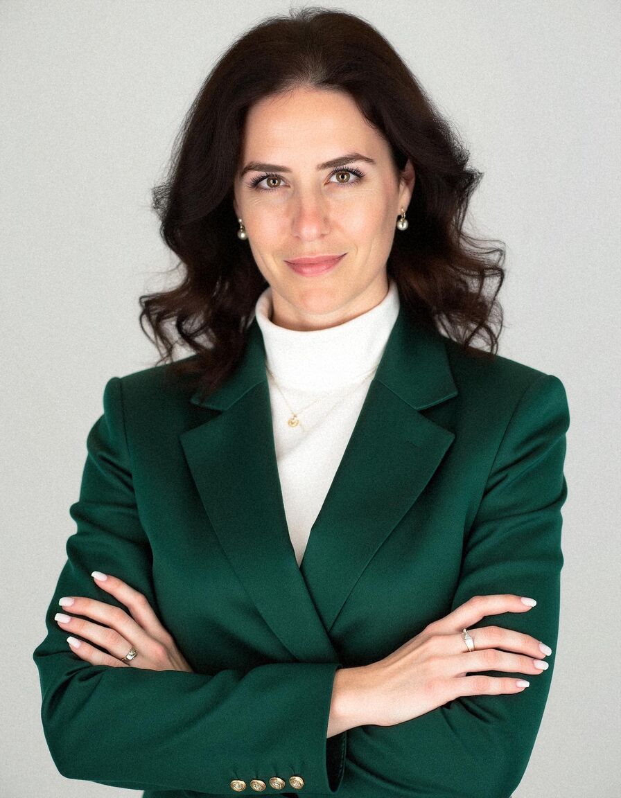 AI headshot of Leila: plain backdrop, green blazer
