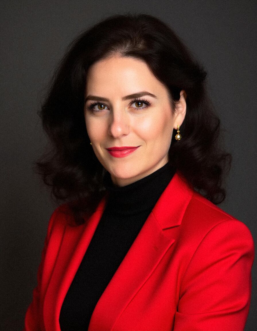 AI headshot of Leila: studio, dark backdrop, red blazer