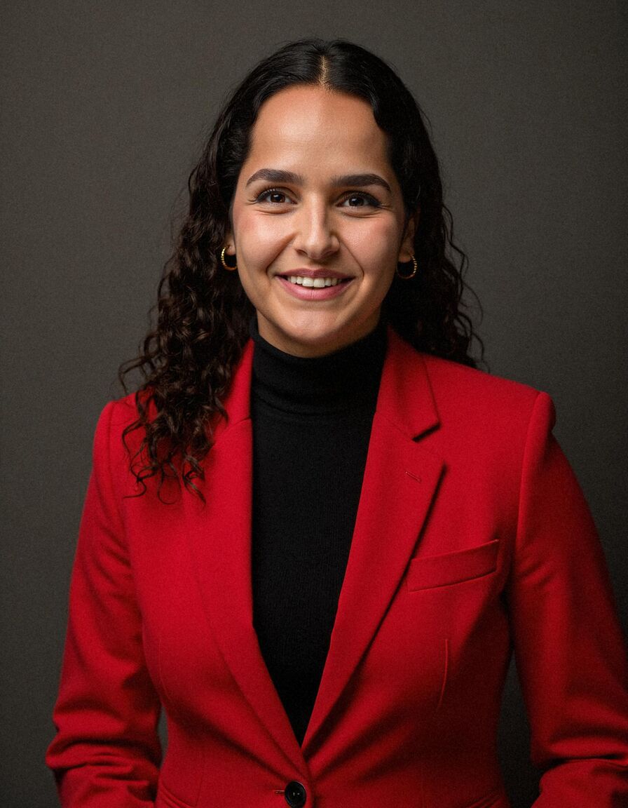 AI headshot of Noa: studio, dark backdrop, red blazer